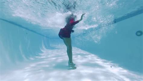 Underwater View Of Black Woman Wearing Dress Falling Into Swimming Pool