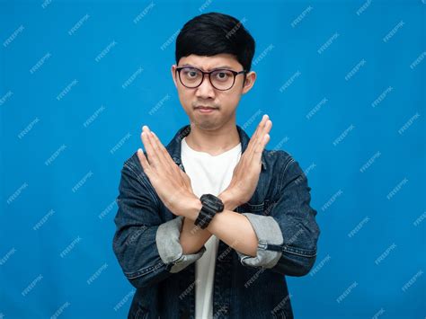 Premium Photo Man Jeans Shirt Wear Glasses And Watch Crossing Arms Disagree Blue Background