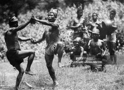 Ritual dance of the Semang people : men dancing and playing music ...