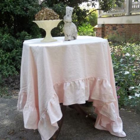 A Table With A White Cloth On It In The Grass