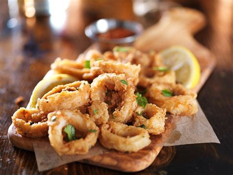 Some Fried Food Is Sitting On A Wooden Table