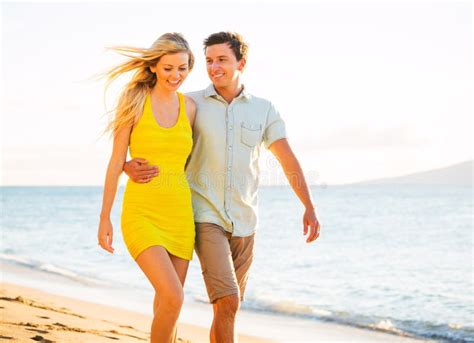 Couple Walking On The Beach At Sunset Romantic Vacation Stock Image