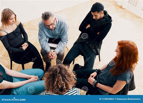 Group Of Teenagers Sharing Text Message On Mobile Phones Royalty Free