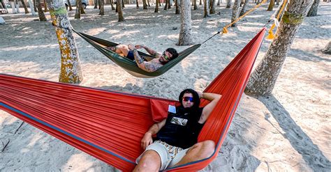 Two People Laying In Hammocks On The Beach · Free Stock Photo