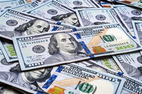 One Hundred Us Dollar Bills Many Banknotes Are Scattered A Pile Of