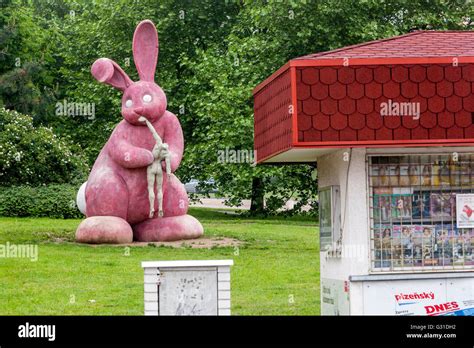 Statue Of A Pink Rabbit That Eats Human Concrete Sculpture On The