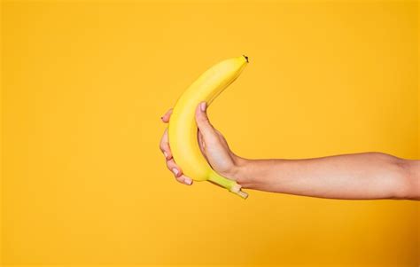 Premium Photo Female Hand Holding Banana Fruit Nutrition Concept