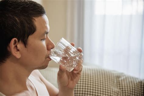 Premium Photo Portrait Of Man Drinking Water From Glass