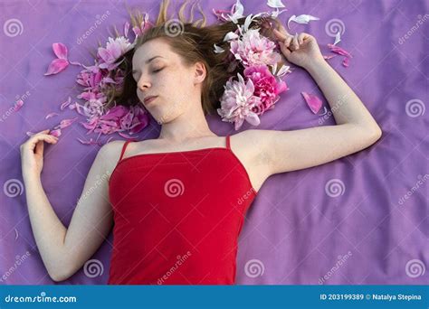 Light Skinned Girl With Freckles In A Red T Shirt Lies With Loose Hair