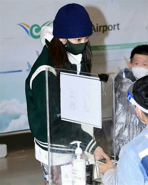 Two People Wearing Face Masks At An Airport Check In Counter With