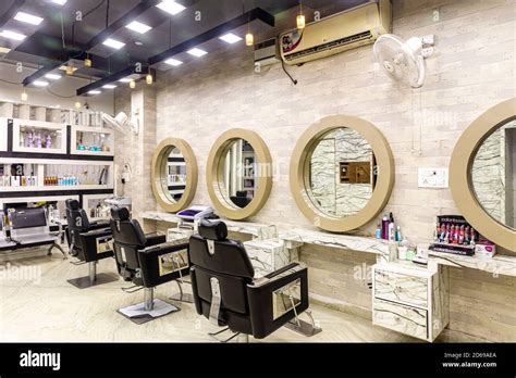 View inside of a modern salon showing mirrors and sitting arrangement. Beauty parlour interiors ...