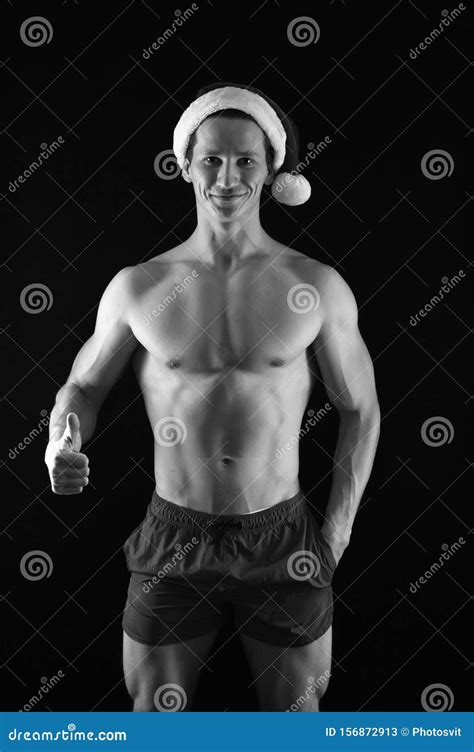 Muscular Man In Santa Hat Present For Xmas New Year Party Santa