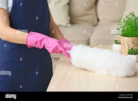 Janitor Cleaning Table In Apartment Stock Photo Alamy