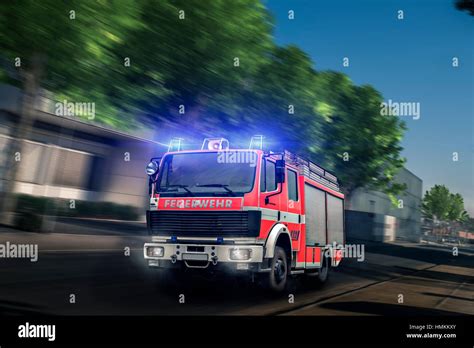 Fire truck driving with blue light Stock Photo - Alamy