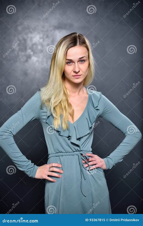 Very Serious Blonde Girl On A Gray Wall Background Stock Image Image