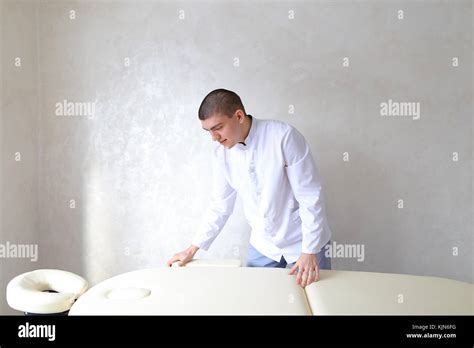 Professional Male Massage Therapist Preparing To Receive Patient Stock