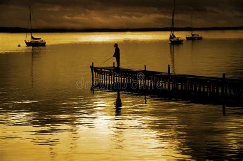 Dock And Fisherman Stock Photo - Image: 27222110