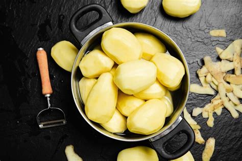 Premium Photo Fresh Peeled Potatoes On A Black Background