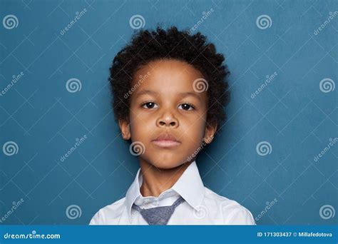 Portrait Of Curious Smart Black Child Boy Student On Blue Background