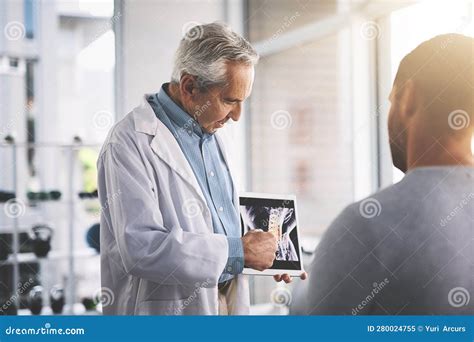 It Doesnt Look Too Bad A Senior Doctor Giving His Male Patient A