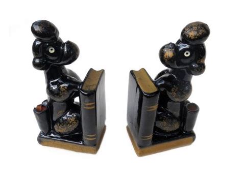 Pair Of Black Bookends With Gold Accents On Each One S Head And Legs