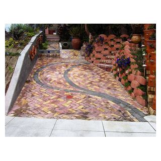 Front Yard With Artistic Driveway Custom Sculptures Planted Walls