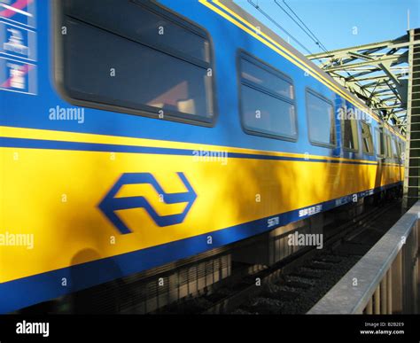 Dutch train passing with Dutch rail logo visible Stock Photo - Alamy