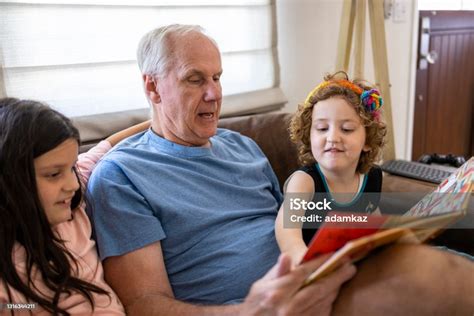 Grandpa Reading With Granddaughters Stock Photo Download Image Now