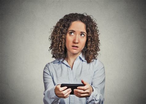 Sad Skeptical Unhappy Woman Texting On Phone Outdoors In Park Stock