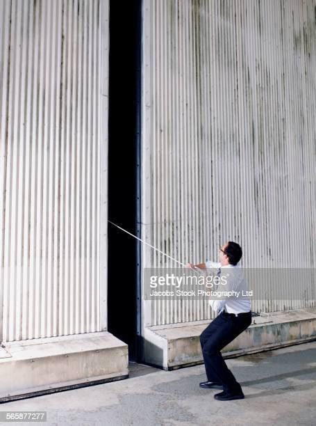 man pulling  rope side view stock  high res pictures