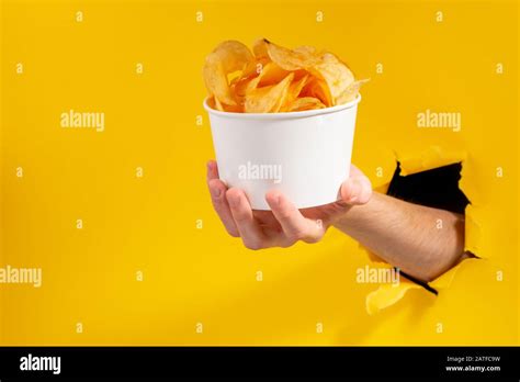 Hand Giving A Cup Of Potato Chips Stock Photo Alamy