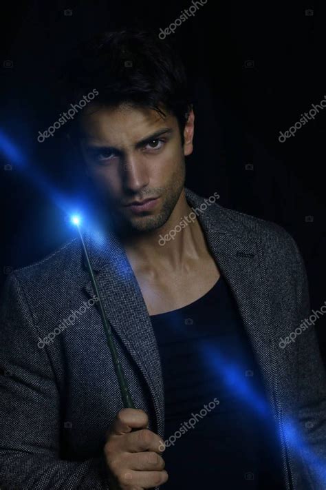 Handsome Wizard Holding A Magic Wand — Stock Photo © Rdrgraphe 129034146