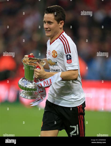 Manchester United's Ander Herrera holds the Emirates FA Cup trophy ...