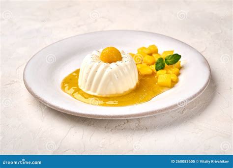 Homemade Panna Cotta With Natural Vanilla Pod Mango Syrup And Mint