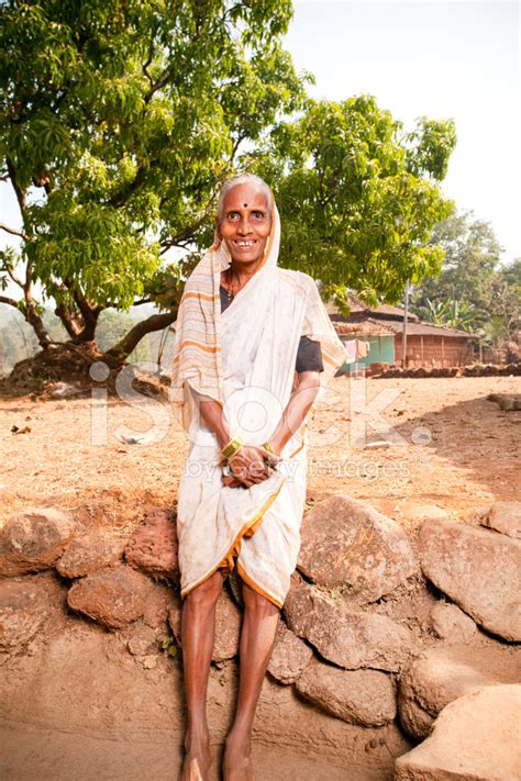 Cheerful Rural Indian Senior Woman Standing In A Village Stock Photo