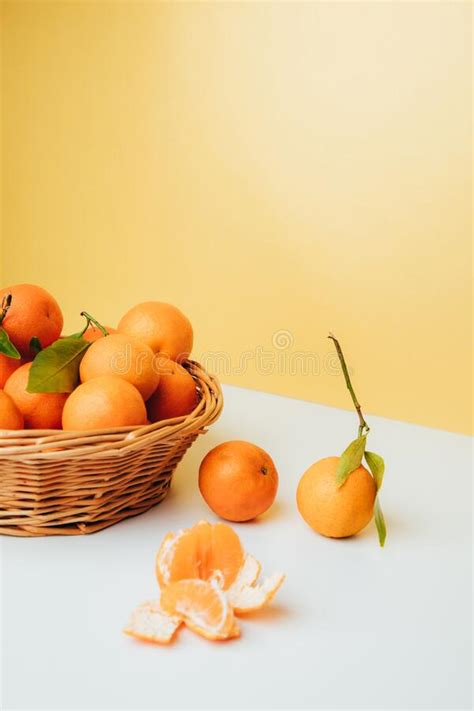 Orange Mandarins Clementine With Green Leaves In Straw Basket On A