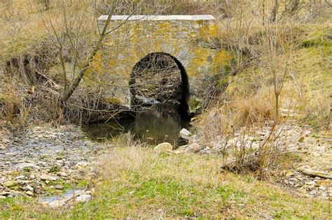 Premium Photo Old Stone Bridge Across Small Stream On Early Spring