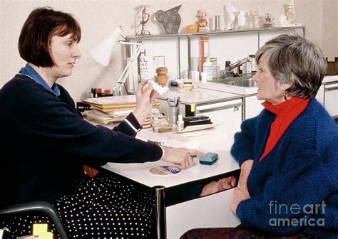 Doctor Showing Asthma Inhalers To Elderly Patient Photograph By Chris Priest And Mark Clarke