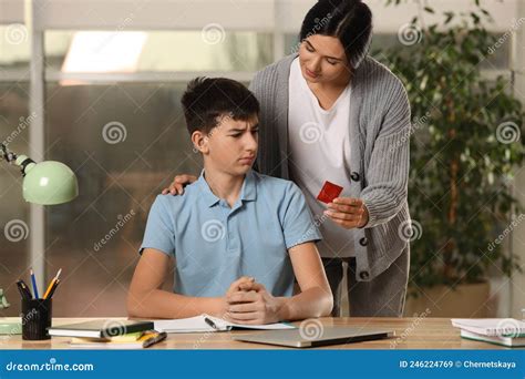 Mother Giving Condom To Her Teenage Son While He Doing Homework At Home