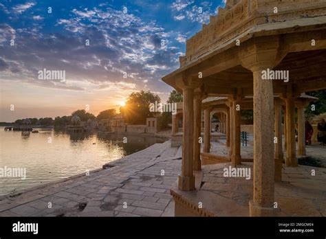 Nice sunset at Gadisar lake, Jaisalmer, Rajasthan, India. Setting sun and colorful clouds in the ...