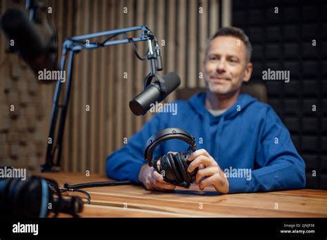 Portrait Of Mature Radio Host Speaking In Microphone While Moderating A