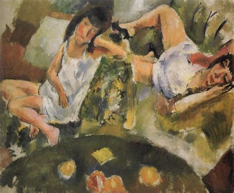 Two Women Laying On A Bed Next To Each Other With Fruit In The Foreground