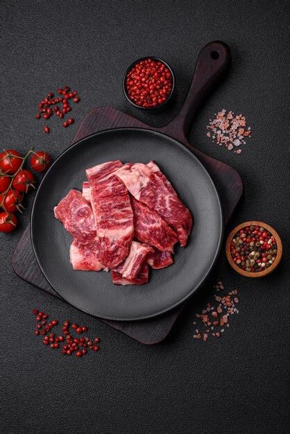 Premium Photo Fresh Juicy Raw Beef Slices With Salt And Spices On A