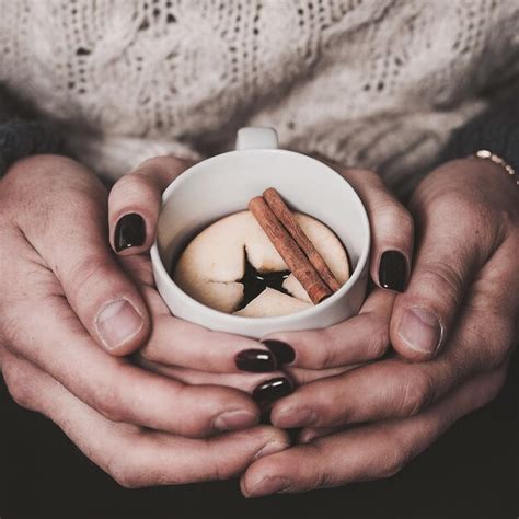 Premium Photo Cropped Image Of People Holding Marshmallow In Cup