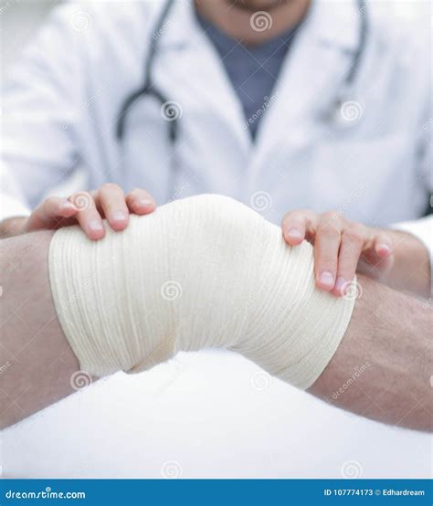 Traumatologist Applying A Bandage On The Knee Stock Image Image Of