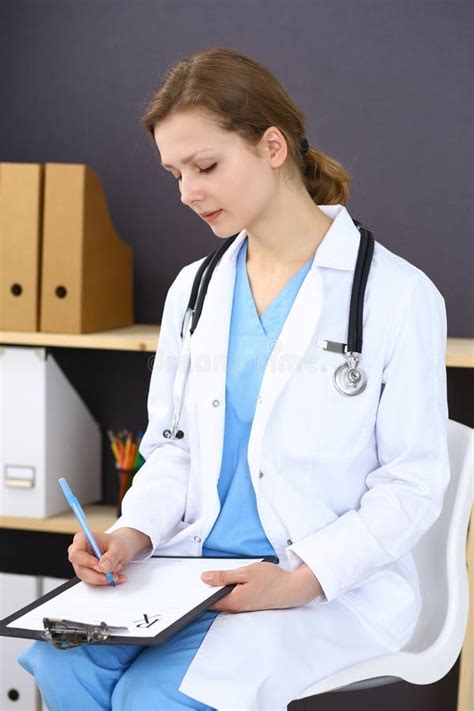 Woman Doctor At Work At Hospital Young Female Physician Write