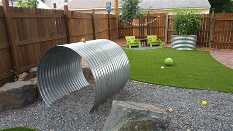 This Is A Dog Scape Play Area With Artificial Grass And Culverts That