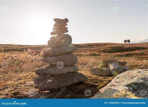 Stack Of Natural Irregular Stones In Grassland With People In Ba Stock