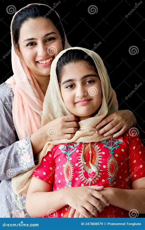 Portrait Of Adorable Smiling Pakistani Muslim Girl With Beautiful Eyes And Her Mother Wearing