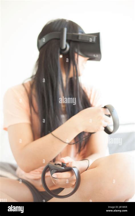 Young Woman Wearing Augmented Reality Oculus Rift Virtual Reality